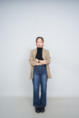 A collection of studio portraits featuring a stylish young woman posing in various confident stances against a clean white background.