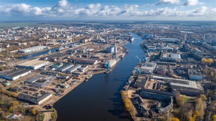 Obraz premium Industrial development in urban river landscape aerial view modern infrastructure cloudy sky