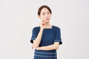 女性　美容看護師　考える　白背景　カメラ目線