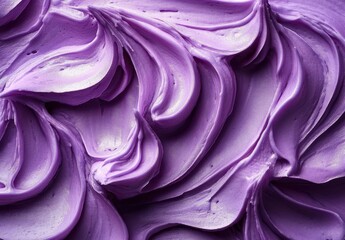 Close-up of smooth, creamy purple frosting with soft swirls and peaks showing rich texture and glossy finish