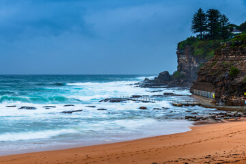 Moody sunrise with waves at the seaside