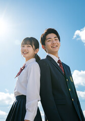 中学生男女・青空背景・写真素材