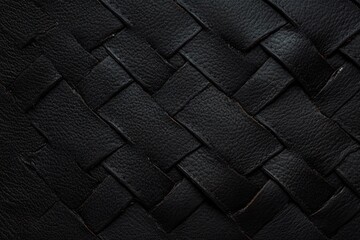 Fototapeta premium close-up of tightly woven black leather strips forming a textured basket weave pattern with visible grain and subtle natural creases