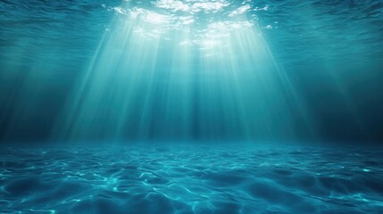 Underwater scene with sunlight beams penetrating clear blue ocean water illuminating the seafloor, creating a calm and serene atmosphere