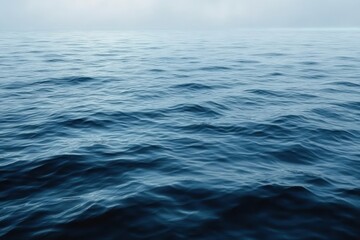 Fototapeta premium Calm ocean surface with gentle waves under soft overcast sky creating a serene and peaceful atmosphere