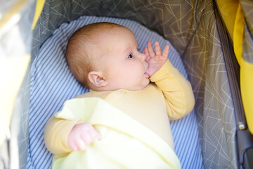 Newborn baby sucks his thumb and falls asleep.