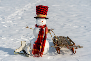 Snowman on snow background. Winter holiday scene. Snowman with scarf and hat. Snow design. Happy...