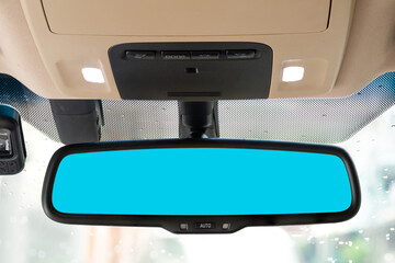 Reflection in a rearview mirror showing a car interior with ceiling lights