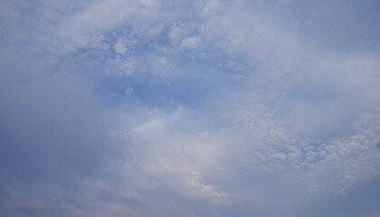a clear afternoon sky with blue and white clouds