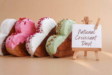 Holiday celebration NATIONAL CROISSANT DAY text Heart shaped different variety flavor croissants on...