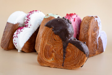 Heart shaped different variety flavor croissants on beige background with copy space. Puff pastry...