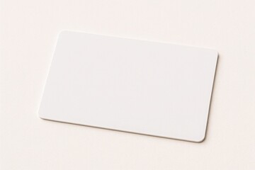 Naklejka premium Blank white plastic card isolated on white background ideal for mockups of business cards ID or membership cards