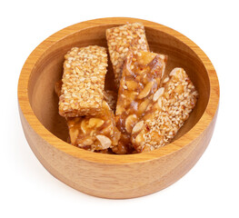 Top view honey bars with peanuts in bowl wooden isolated on white background.
