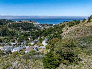 Aerial view of residential neighborhoods, coastal roads, and the Pacific Ocean from the hillside...