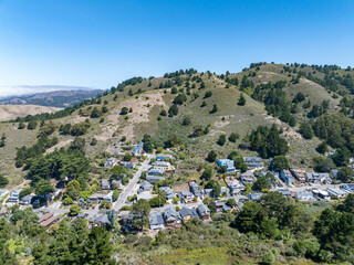 Aerial view of residential neighborhoods, coastal roads, and the Pacific Ocean from the hillside...