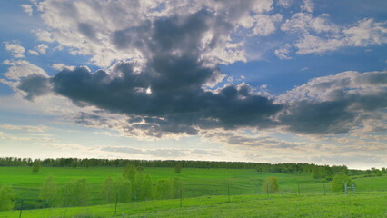 A Serene and Picturesque Green Landscape Set Beneath Dramatic and Beautiful Clouds Above Time lapse.