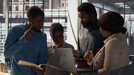 Multinational company workers meet to plan a project focused on growth, discussing resource...