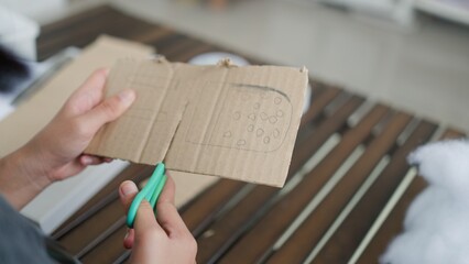 Asian girls doing creative DIY activity at home, developing skills and imagination in a...