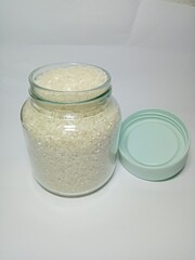 Glass jars containing rice that are almost full of food storage (rice) neatly and cleanly, perhaps for household purposes or kitchen aesthetics.