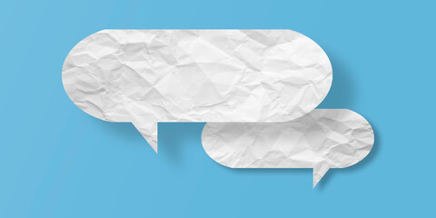 White speech bubble crumpled paper isolated on light blue background
