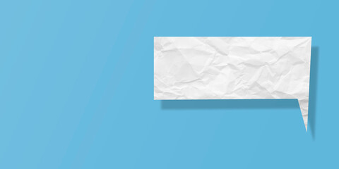 White speech bubble crumpled paper isolated on light blue background