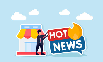 Businessman holding hot news label with fire next to store illustration of latest news about business world