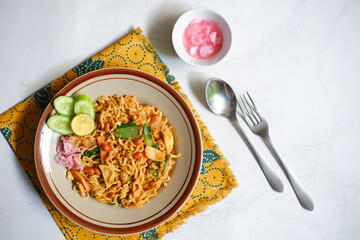 A plate of mie Aceh in white background 
