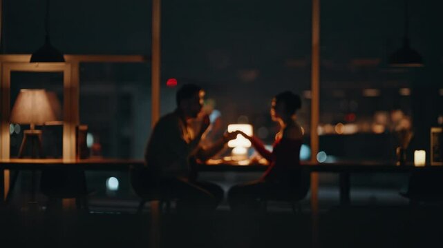 Romantic man holding hand beloved woman at night date in luxury restaurant.
