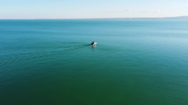 Drone view of Kis Mohle pier in open water near horizon with faint landscape in background