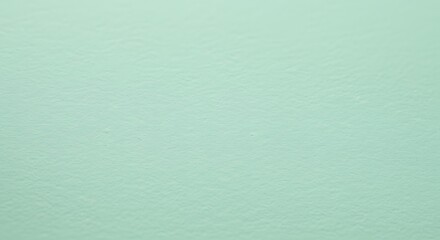 Light green painted surface with subtle texture