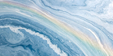 Blue marble with a rainbow-colored band stretching diagonally, featuring subtle white speckles and swirling patterns resembling oceanic depths