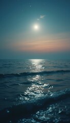 Fototapeta premium Serene Ocean at Night: Moonlit Water, Gentle Waves, Tranquil Twilight Sky, and Sparkling Reflections