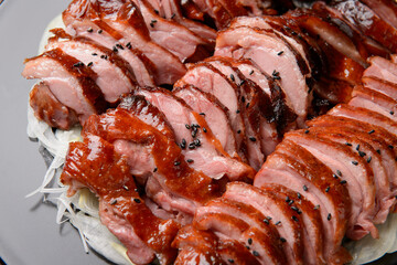 Smoked duck slices sprinkled with black sesame seeds
