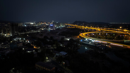 India's longest sea bridge: Trans-Harbour Sea Link. Atal Setu sea bridge in Mumbai, Maharashtra, India. Time-lapse of a city at night with bright skyscrapers and a dense network of glowing buildings.