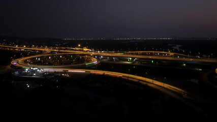 India's longest sea bridge: Trans-Harbour Sea Link. Atal Setu sea bridge in Mumbai, Maharashtra, India. Time-lapse of a city at night with bright skyscrapers and a dense network of glowing buildings.