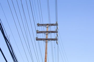Fototapeta premium A view of a utility pole and power lines.