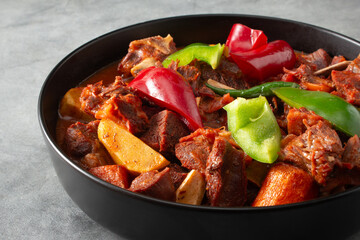 A closeup view of a bowl of calderatang kambing.