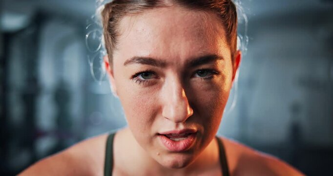 Woman, breath and face with tired for exercise, intense workout and wellness as bodybuilder. Female person, sweat and break as athlete for health, challenge and training for fitness or sport in gym