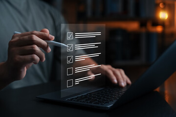 Digital checklist on screen with person using stylus and laptop, representing productivity, task management, online planning, time management, workflow, and digital organization concept.