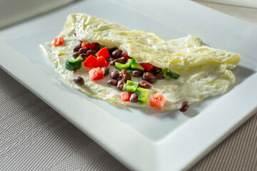 A view of an egg white Southwestern omelet, on a plate.