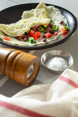 A view of an egg white Southwestern omelet, on a plate.