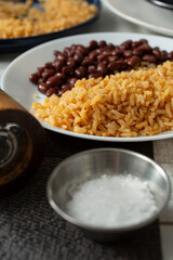 A view of a plate of Mexican rice and black beans.