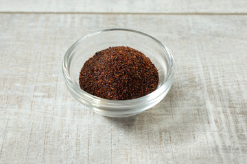 A view of a condiment cup of chipotle powder.