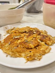 Authentic Thai-style omelet (Kai Jeow Kai Mod Daeng) with red ant eggs, a unique and savory delicacy known for its slightly tart taste and delicate texture, a popular seasonal dish.