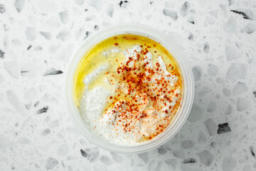 A top down view of a container of tzatziki.