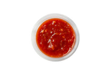A top down view of a condiment cup of shatta, against a white background.
