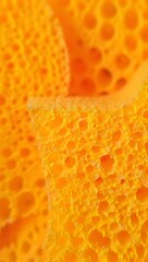 Close-up of a vibrant sponge texture. Capturing the intricate porous surface and sunny hue.