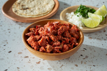 A view of a bowl of al pastor meat.