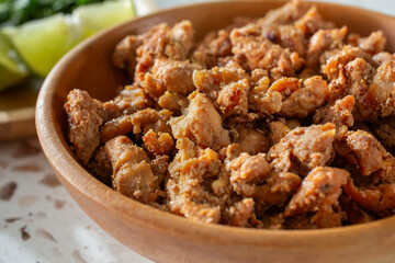 A closeup view of a bowl of pollo asado.