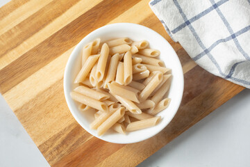 A top down view of a bowl of gluten-free penne pasta.